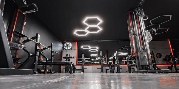 Empty, minimalist gym space with natural light, ready for a workout.